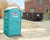 Portable Restroom And Roll Off Dumpster On A Construction Site