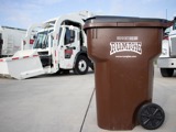 Rumpke Wheeled Commercial Cart In Front Of Front Load Truck