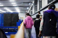Recycling Tour Group Walking On Recycling Center Tour Platform