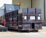 Rumpke Commercial Trash Compactor At A Commercial Facility