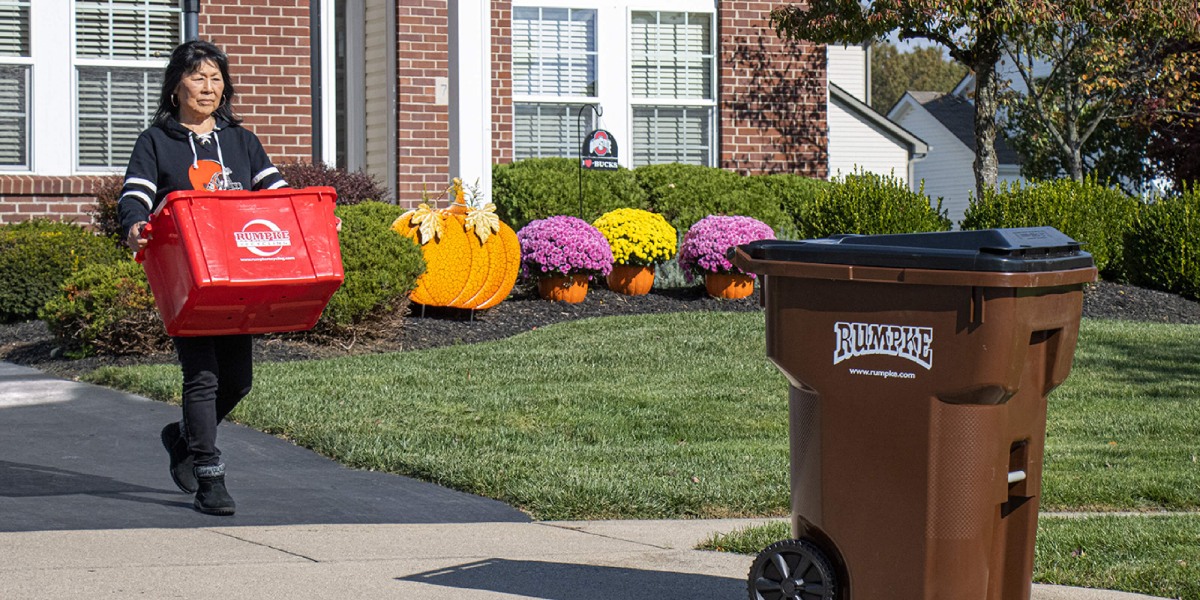 Two Rumpke Recycling Bins Outside of House