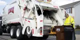 Rumpke Driver Emptying Residential Trash Into Trash Truck