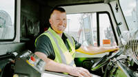 Rumpke Truck Driver Smiling In Driver Seat