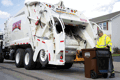Rumpke Driver Emptying Residential Trash Into Trash Truck