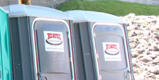 Two Green Wheelchair Accessible Porta Potties